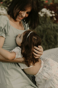 mom hugging toddler daughter