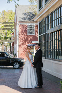 couple holding hands smiling on main street on nantucket
