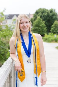 A classic photo taken by Studio Roscher of a happy high school female graduate in Alexandria, VA