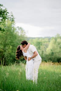 Engaged couple kissing each other during an engagement photography session in Prince Edward County.