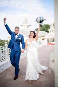 Bride and groom celebrating in front of a carousel at an Orlando wedding