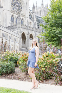 A classic photo taken by Studio Roscher of a happy high school female graduate at National Cathedral in Washington, DC