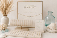 Elegant jewelry display with gold chains, turquoise accents, seashells, glass vase, pampas grass, and a sign reading “Permanent Jewelry.”