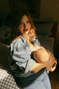 Mother nursing her baby during an at home family photo session in Houston Texas