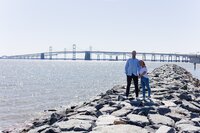 A glossy photograph taken by Studio Roscher of a happy engaged couple seaside in Richmond, VA