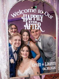 Wedding party posing by a Happily Ever After sign at an Orlando reception