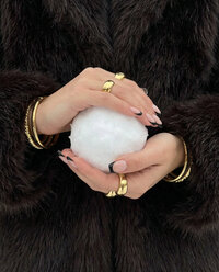 Powder - Hands holding snowball in black fur coat outdoors - TVS