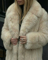 Powder - Woman in luxurious cream fur coat displaying diamond ring - TVS
