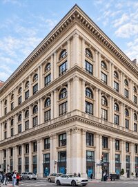 Historic building featuring an ornate limestone facade with classical columns and carved stone details.”