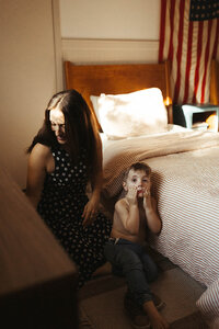 A mother tries to get her son dressed during a family photo session in Houston TX
