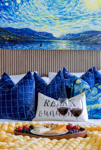 Relaxing bed with luxe furnishing, area inside Stargazer Suite, perfect for unwinding after a long lake day