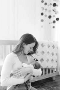 A glossy photograph taken by Studio Roscher of a new mom and her newborn in Richmond, VA