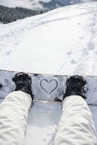 Powder - Snowboarder_s perspective of heart symbol on snowy slope - TVS