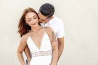 Couple embracing on the sand dunes during a Palm Springs promo photography session