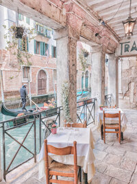 Charming European cafe terrace with outdoor seating on a picturesque Mediterranean street