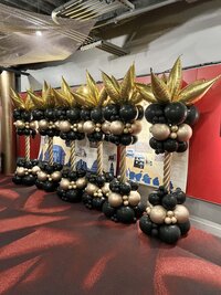 black and gold balloon towers for event