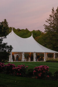 Reception tent during a purple and pink sunset after a wedding at the Steven's Osgood Estate in Massachusettes.