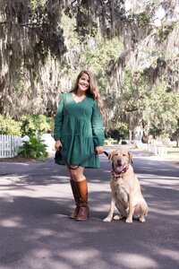 A glossy photograph taken by Studio Roscher of a happy female dog owner with her dog in a park in Savannah, GA