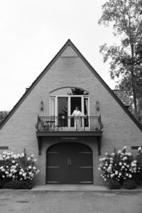 bride looking out a balcony, preparing for her wedding ceremony
