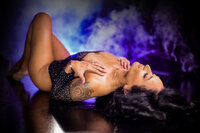 Woman being guided through posing during her first boudoir photography session near Wichita.