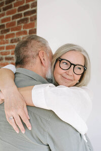 happy older woman hugging her husband