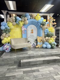 Winnie the pooh themed baby shower balloons and backdrop