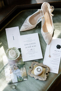 close up of wedding accessories sitting on top of a green window bench
