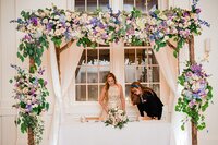 Wedding planner with Weddings & Events by Raina assists bride with her welcome speech