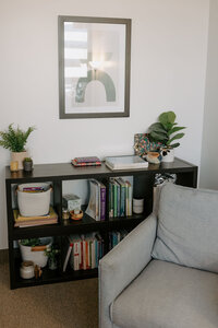 Photo of bookshelf in therapy room with chair