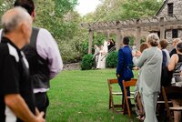 Wedding Planners with Weddings & Events by Raina assist the bride down the stairs to the aisle