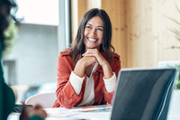 woman at desk smiling