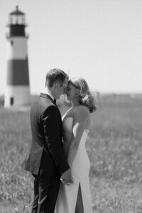 bride and groom pressing heads together at sankaty lighthouse on nantucket