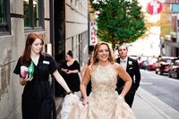 Wedding planner with Weddings & Events by Raina assists the bride during photos