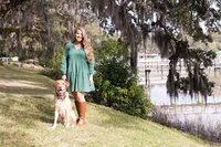 A glossy photograph taken by Studio Roscher of a happy female dog owner with her dog in a park in Savannah, GA