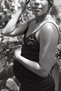 A mother holds her pregnant belly during a Houston Texas Maternity photo session