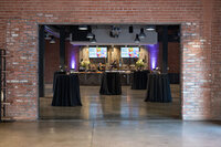 Corporate event venue prepared with cocktail tables, floral arrangements, catering stations and event lighting in Phoenix Arizona