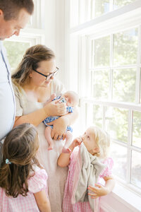 A mother and her children during a newborn photography session in Wilmington, North Carolina