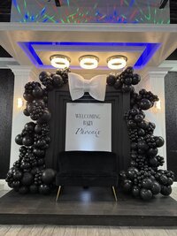 shiny black balloons with backdrop for event