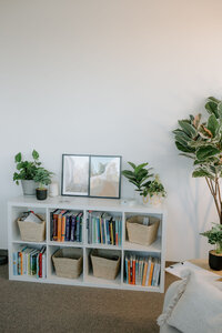 cubicle in therapy office with books and baskets.