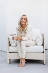 Celeste posed against a light backdrop during a La Quinta branding photography session