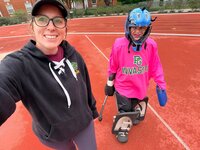 Emily, the photographer of Studio Roscher, smiling with her daughter at a field hockey practice