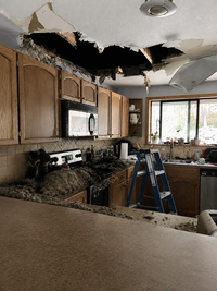Lightening fire damage to a kitchen ceiling before restoration