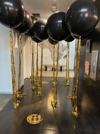 black and gold balloons for corporate event