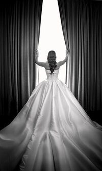 Black and white photo of a bride from behind showing her gown at an Orlando wedding