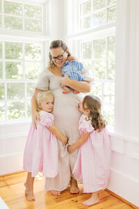 A mother and her children during a newborn photography session in Wilmington, North Carolina