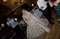 radiant-bride-dancing-golden-embroidered-gown-large
