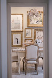 Gallery wall of framed client wedding portraits displayed at Sarah DiCicco's cottage studio
