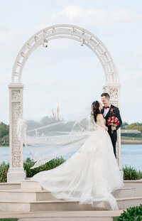 bride and groom posed with Disney World in background