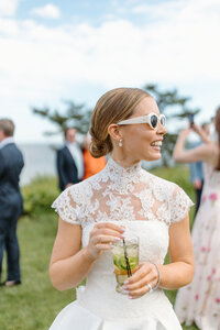 bride having drink at wianno club with sunglasses on