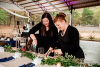 Weddings planners with Weddings & Events by Raina lighting candles before the wedding reception